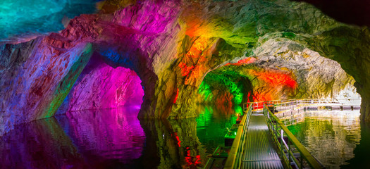 Cave with color highlights. Flooded mine. Failure in Ruskeala. Karelia. Russia.