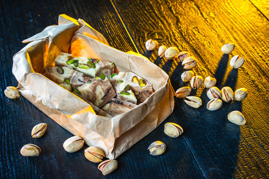 Halva lies on the table. Halva with pistachios.