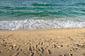 footprints in the sand on the beach