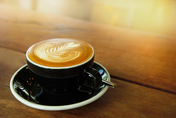 cup of black coffee drink on wood table cafe with morning light background