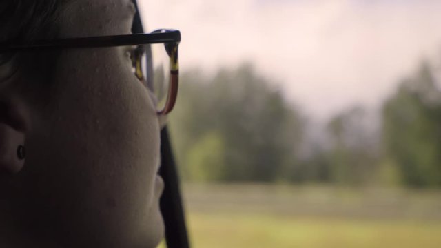 Closeup Of Smiling Road Tripper, Enjoying The Scenery From Backseat (Slow Motion)