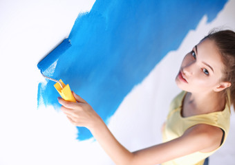 Beautiful young woman doing wall painting