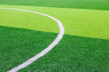 Photo of a green synthetic grass sports field with white line shot from above