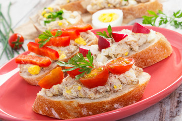Crusty sandwiches or baguette with mackerel or tuna fish paste on plate, healthy nutrition