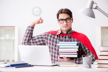 Super hero student with a laptop studying preparing for exams