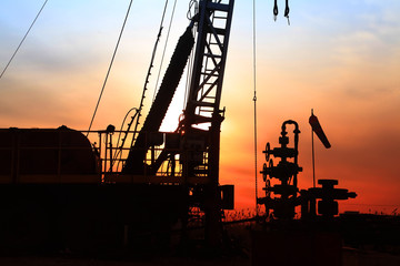In the evening, the silhouette of oilfield derrick