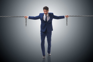 Businessman holding chains in business concept