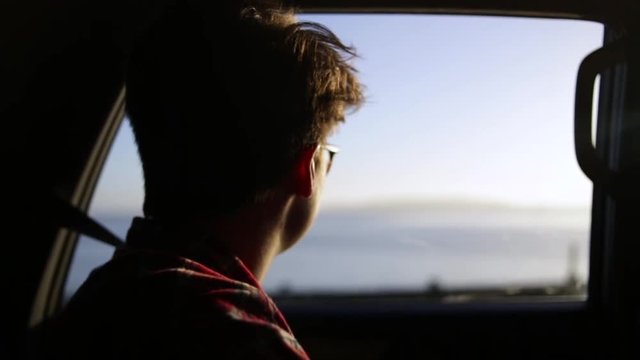 Closeup Of Person Looking Out Car Window On A Sunny Summer Day On The Oregon Coast (Slow Motion)