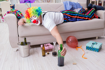 Fototapeta na wymiar Drunk clown celebrating having a party at home