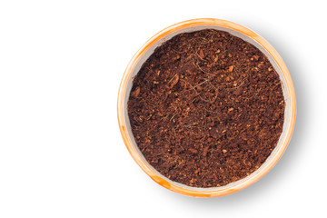 Flowerpot filled with organic potting soil on the white background. Top view.