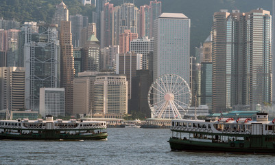 Fototapeta na wymiar Scene of Hong Kong skyline with boats in Victoria Harbor