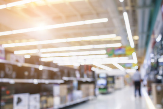 Television show in electronic department store in shopping mall blurred background