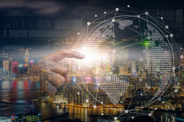 Hand touching the global network with the earth over the Hong Kong Cityscape at night time which can see down town and Victoria harbor, business innovation and technology concept