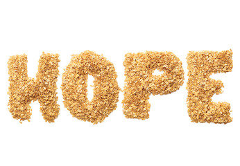 "Hope" written with oat grains word. Shape of oatmeal flakes on isolated white background