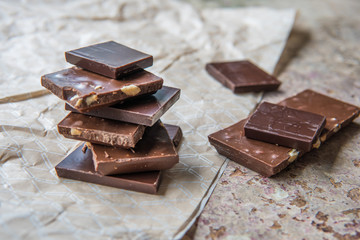 Dark chocolate stack with hazelnuts. Sweet dessert