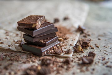 Dark chocolate stack with hazelnuts, selective focus