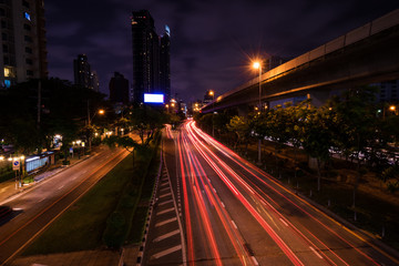 Fototapeta na wymiar abstract night light tails in urban cityscape