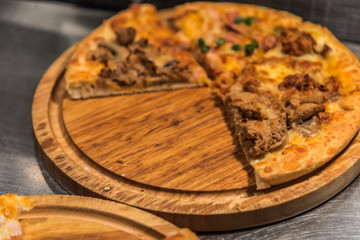 Pizza served on wooden circle board