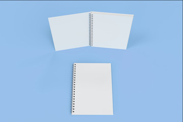 Two notebooks with spiral bound on blue background