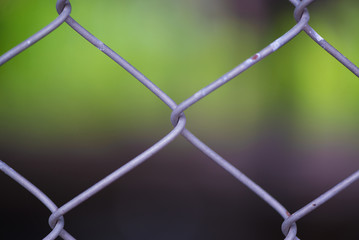 Rusty Chain Link Fence of steel netting on blur background.