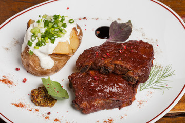 Barbecue ribs with baked potatoes.