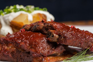 Barbecue ribs with baked potatoes.