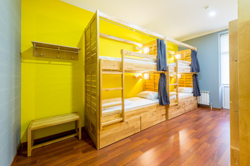 Hostel dormitory beds arranged in room