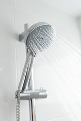 shower head with water drops flowing