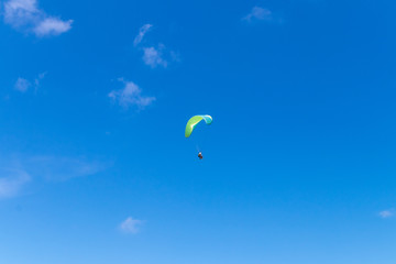 Raraplane flying in the beautiful sky. Tropical Bali island, Indonesia. Extreme sport.