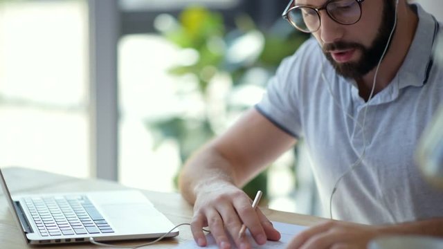 Young man asking groupmate for help through video call