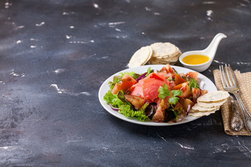 Healthy food - vegetables and salmon salad on a dark background. Selective focus. Copy space