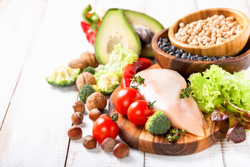Raw chicken and fresh vegetables on a table. Healthy food. Selective focus. Copy space