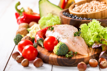 Raw chicken and fresh vegetables on a table. Healthy food. Selective focus. Copy space