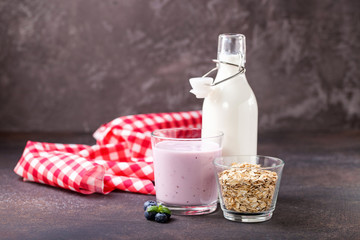 Milk, yogurt and oatmeal against a dark background. Selective focus. Copy space