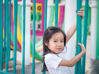 Happy asian baby child playing on playground, wearing white t shirt