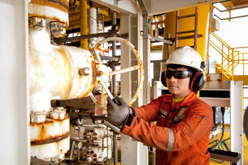 Technician or worker on the job calibrate or function check pneumatic control valve in process oil and gas platform offshore,technician