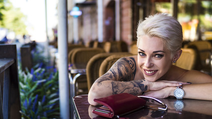 Tattoed woman in cafe