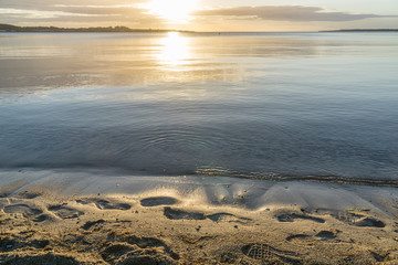 Beautiful sunrise in the summer by the quiet sea