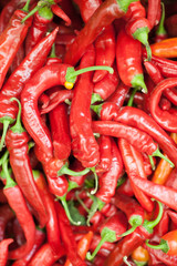 Red peppers background texture of hot red chili, seasoning paprika, fiery red hot in the kitchen a dish of red pepper for sale