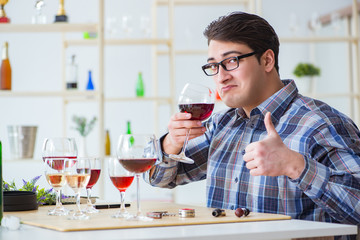 Professional sommelier tasting red wine 