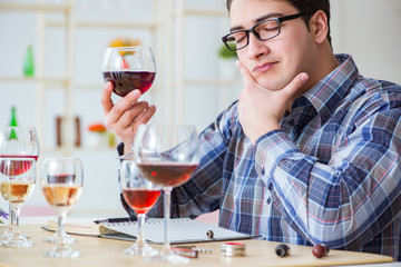 Professional sommelier tasting red wine 