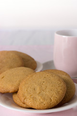 Honey Snaps on Plate with Cup on Pink Cloth Vertical with Copy Space