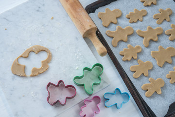 Preparing Gingerbread Cookies on Marble Slab with Rolling Pin and Cookie Cutters Horizontal from Above