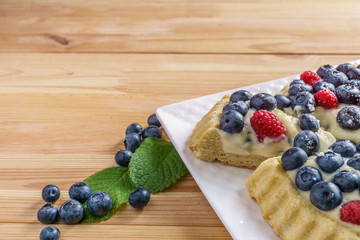 Dessert berry cake blueberry tart with fresh berries and pastry cream