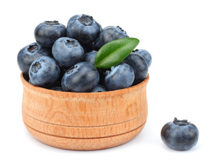 blueberries in wooden bowl isolated on white background