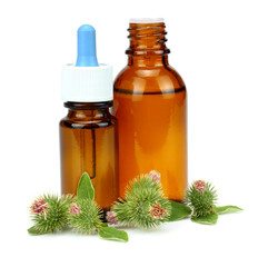 bottle with burdock (castor, agrimony) oil isolated on white background
