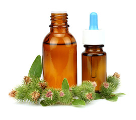 bottle with burdock (castor, agrimony) oil isolated on white background