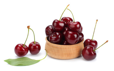 cherries in wooden bowl isolated on white background.
