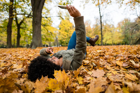 Woman clicking selfie in an autumn park