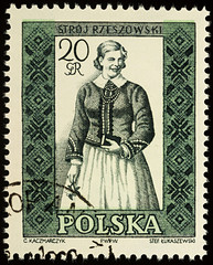 Woman in Polish traditional dress on postage stamp